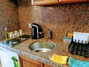 Fridge, stovetop, electric kettle, cookware/dishes/utensils