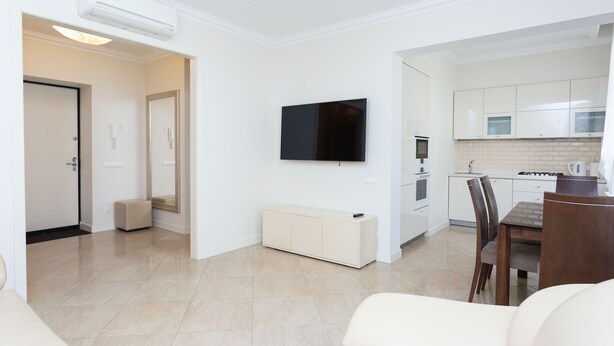 A modern apartment with a living room, dining area, and kitchen. - MinskLux Apartments Deluxe 1 bedroom on Nezavisimosti ave. 13 (Minsk)