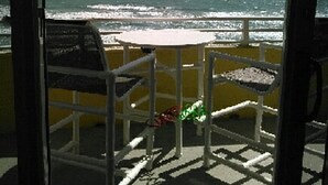 A balcony with a view of the ocean. There are two chairs and a small table. - Ocean Walk Resort 1305 w/Private Ocean Front Balcony (Daytona Beach)