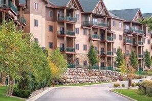 Stunning residential building with balconies and beautifully maintained grounds.