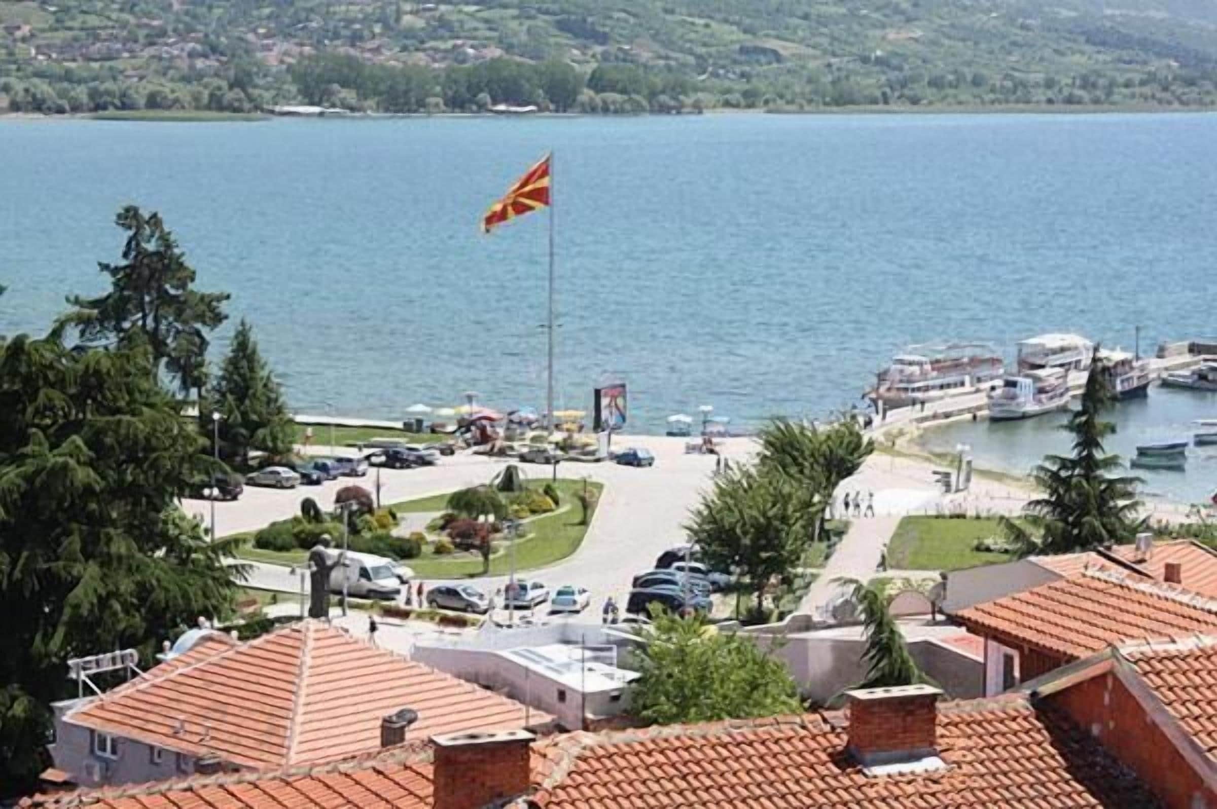 A coastal town with a flag, boats, and a marina.