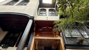 A staircase leading to a building entrance with a wooden door and a sign above it. - Tahtakale Konağı Private & Luxury (Bursa)