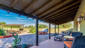 An outdoor patio area with a covered seating area, a barbecue grill, and a cactus plant. - Central Scottsdale Home - Minutes to Old Town (Scottsdale)