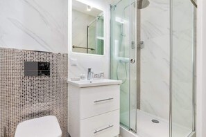 Chuveiro, secador de cabelo, toalhas de banho, shampoo