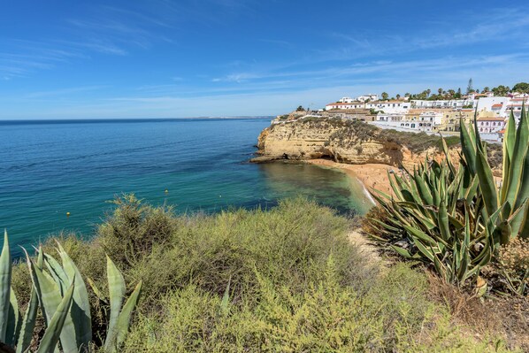 A coastal town with buildings on a cliff overlooking the sea.