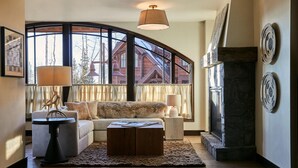 A cozy living room with a sofa, coffee table, and a fireplace. - Madeline Hotel And Residences, Auberge Resorts (Telluride)