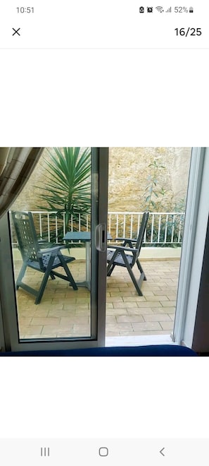 Enjoy the serene view from your room's patio, where you can sit and relax with a potted plant nearby.