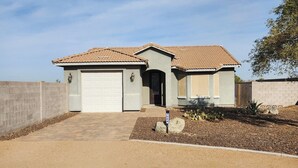 A single-story house with a tiled roof, a garage, and a landscaped front yard. - Hombre Guest House in beautiful Arizona  (Queen Creek)