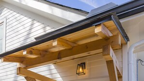 A house with a light blue door, wooden porch beams, and a small porch area. - The Russell House - Walk to Restaurants & Bars! (Nashville)