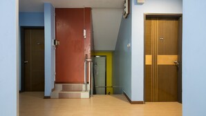 A hallway with three doors, each marked with a number. - OYO 1103 Borneo Inn (Kota Kinabalu)