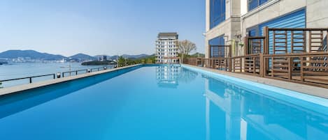 Seasonal outdoor pool, open 11:00 AM to 9:00 PM, pool umbrellas