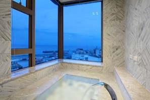 A spa area with a large window offering a city view.