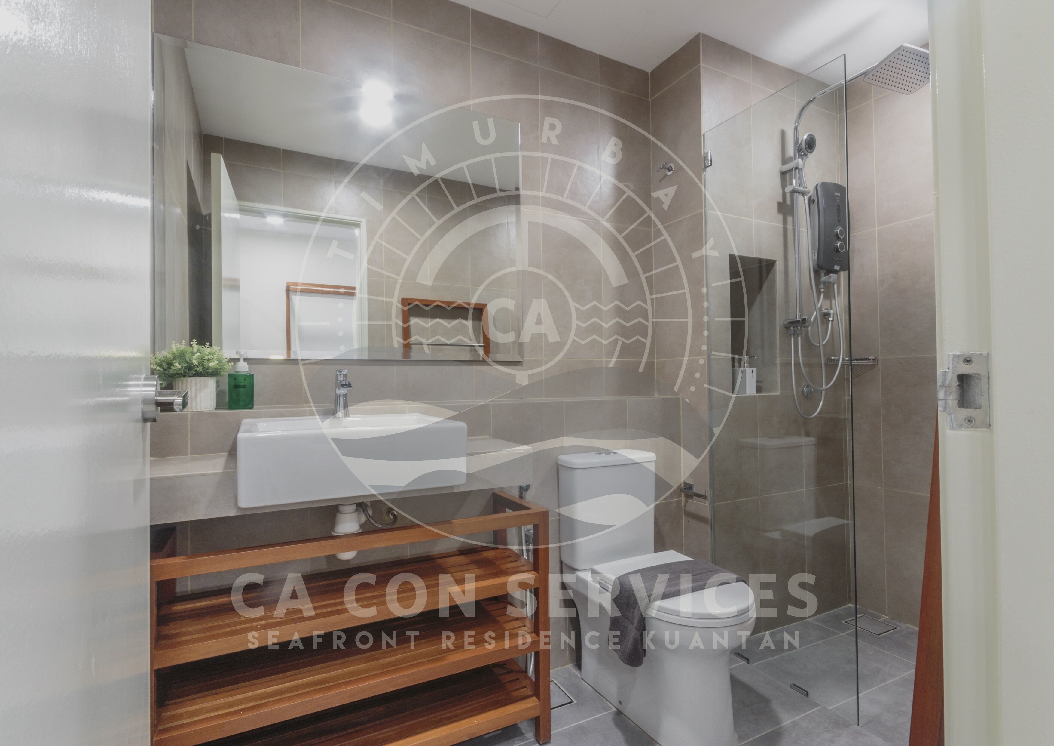 A modern bathroom with a glass shower enclosure, a sink, and a toilet.