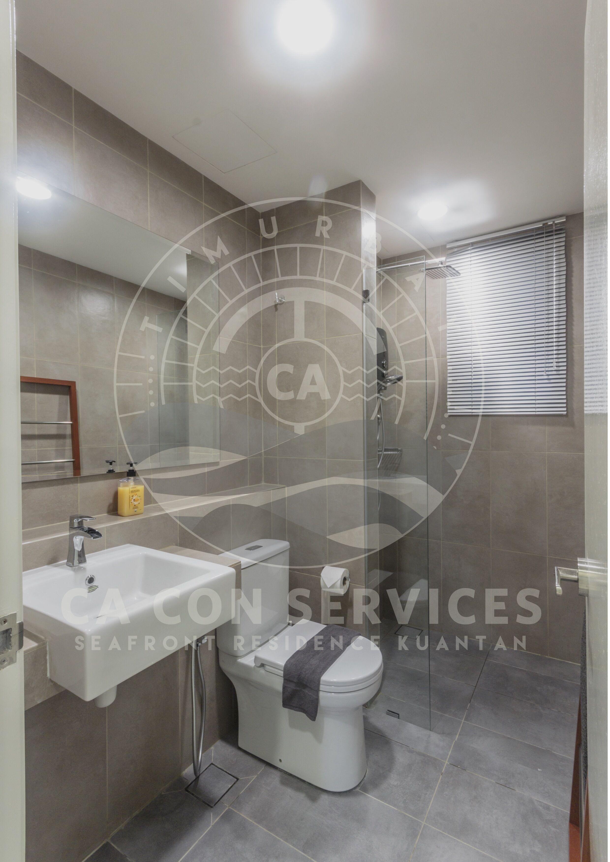 A modern bathroom with a bathtub, sink, and toilet.