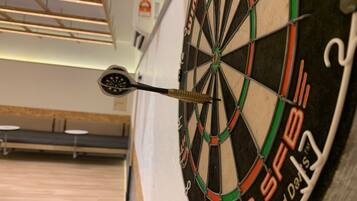 A dartboard with a dart in the center, mounted on a wall.