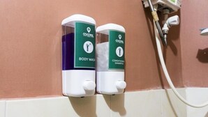 Two body wash dispensers mounted on a wall with a water connection. - El Moro Beach Resort by Cocotel (Boracay Island)