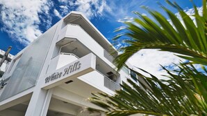 A modern building with a prominent "White Hills" sign. - FreedomHills A (Tomigusuku)