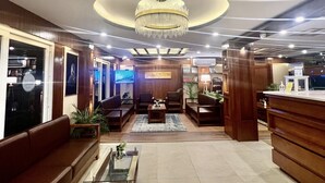 A spacious lobby with a chandelier, seating area, and a reception desk. - Himalayan Suite Hotel (Kathmandu)