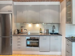 A modern kitchen with stainless steel appliances, a built-in oven, and a sink. - Levin rinnelinna a8 by Interhome (Kittilä)
