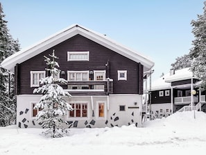 A two-story building with a dark facade, multiple windows, and a balcony. - Levin rinnelinna a8 by Interhome (Kittilä)