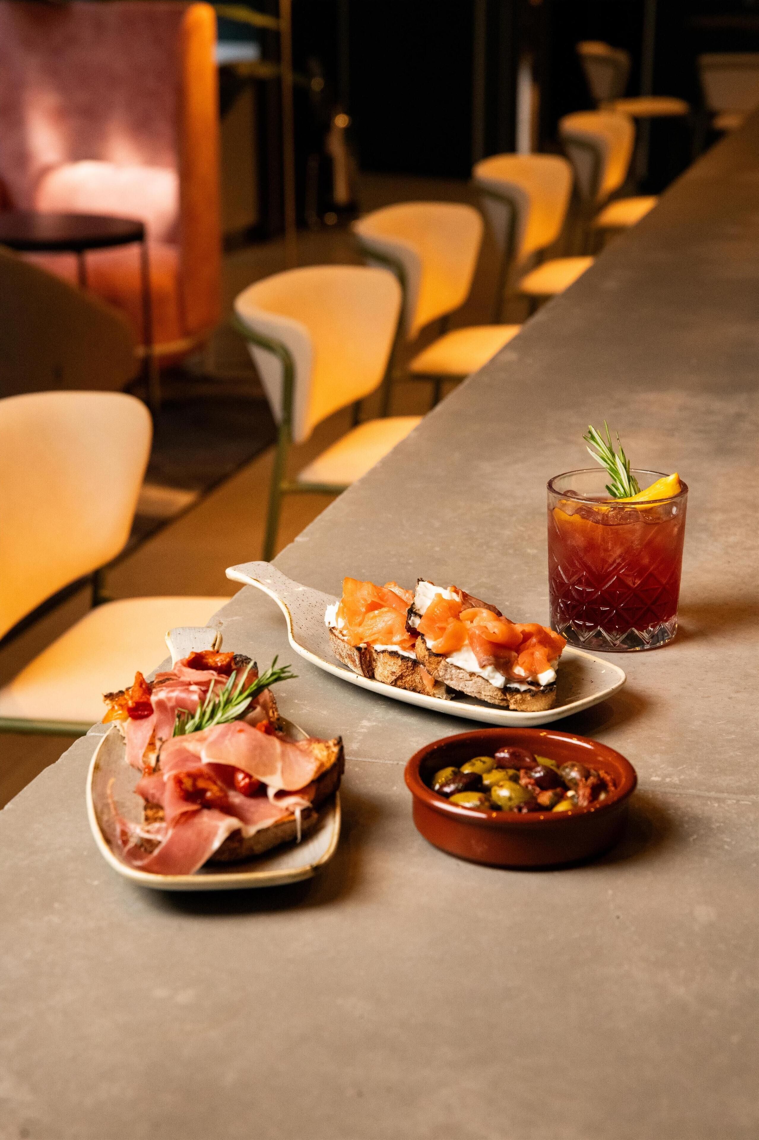 A dining table with plates of food and a drink.