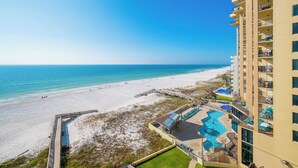 A beach view from a high-rise hotel with a pool area and a boardwalk. - **WEEKLY SPECIALS!** Phoenix II - 7th Floor - 2 Bedroom (Orange Beach)