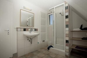 Een douche, handdoeken, toiletpapier