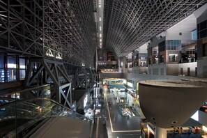 A modern indoor space with a high ceiling, glass railings, and a central atrium. - Hotel Excellence Kyoto Ekimae (Kyoto)
