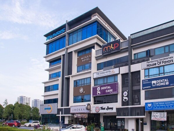 A multi-story building with various businesses including a hotel, dental clinic, and a restaurant. - OYO 89576 Mokka Hotel (Kuala Lumpur)