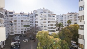 A multi-story residential building with balconies, a parking area, and a tree in the foreground. - B17 - The Stunning Seaview Apartment (Lagos)