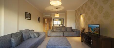 Apartment, 3 Bedrooms | Living area | Flat-screen TV