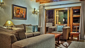 Family House, 3 Bedrooms | Living room | 32-inch flat-screen TV with digital channels, TV, fireplace - Cambalala Kruger Park Lodge (Mbombela)