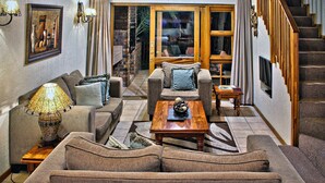 Family House, 3 Bedrooms | Living area | 32-inch flat-screen TV with digital channels, TV, fireplace - Cambalala Kruger Park Lodge (Mbombela)