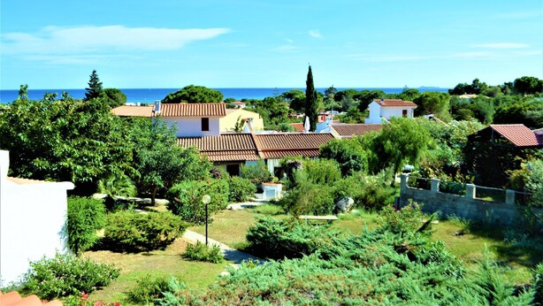 A residential area with houses, a garden, and a view of the sea. - New valmar Villa Camboni (Costa Rei)