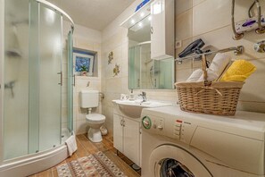 Shower, hair dryer, towels, toilet paper