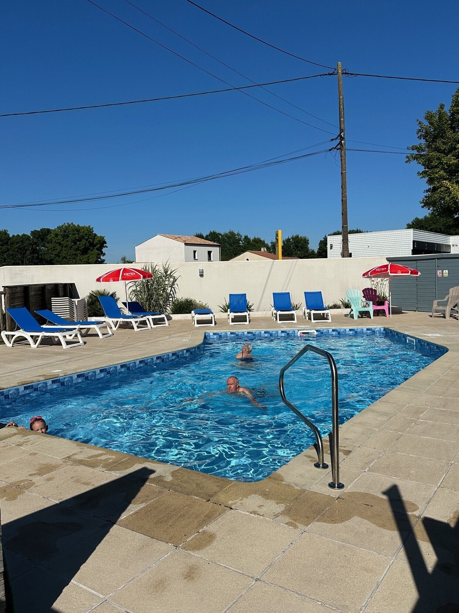 Seasonal outdoor pool, open 10:00 AM to 8:00 PM, pool umbrellas