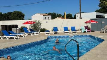 Seasonal outdoor pool, open 10:00 AM to 8:00 PM, pool umbrellas