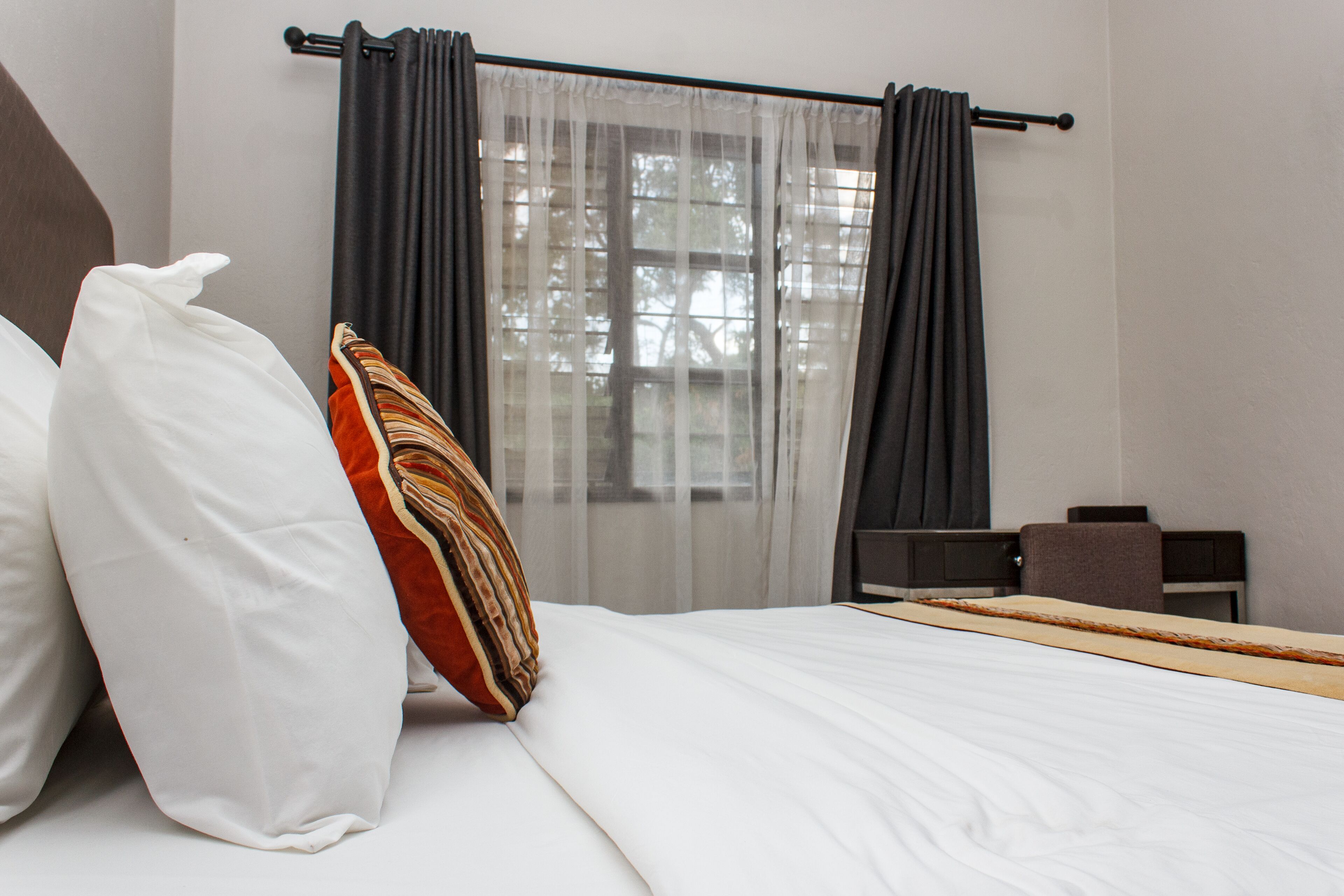 Una habitación de hotel con una cama, un escritorio y una silla.