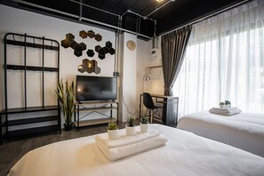 A modern hotel room with a large bed, a desk, a TV, and a wall-mounted shelf with hexagonal decorations. - My Loft Hotel (Chiang Mai)