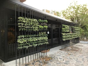 A building with a black metal fence and vertical gardens. - My Loft Hotel (Chiang Mai)