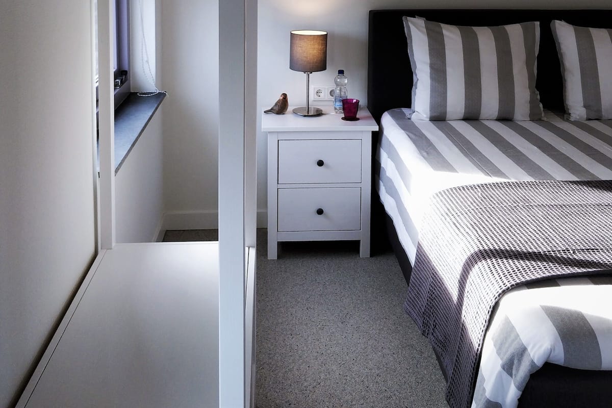 Hypo-allergenic bedding, desk, laptop workspace, blackout curtains