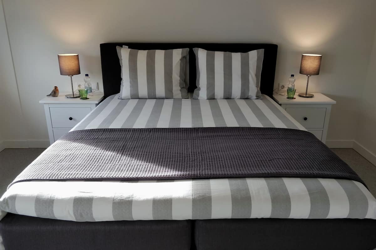 Hypo-allergenic bedding, desk, laptop workspace, blackout curtains