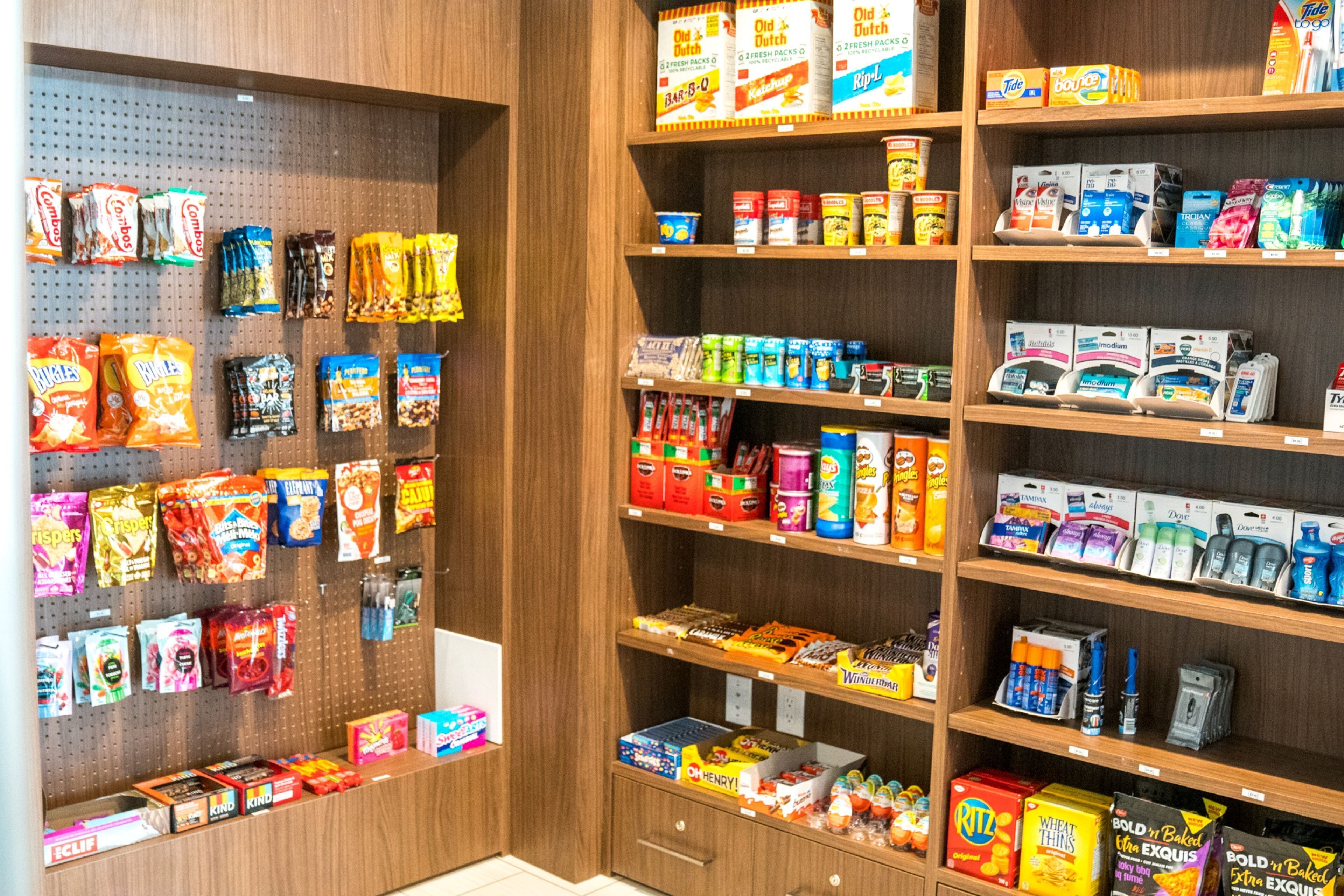 A grocery store aisle with various snack and household items.