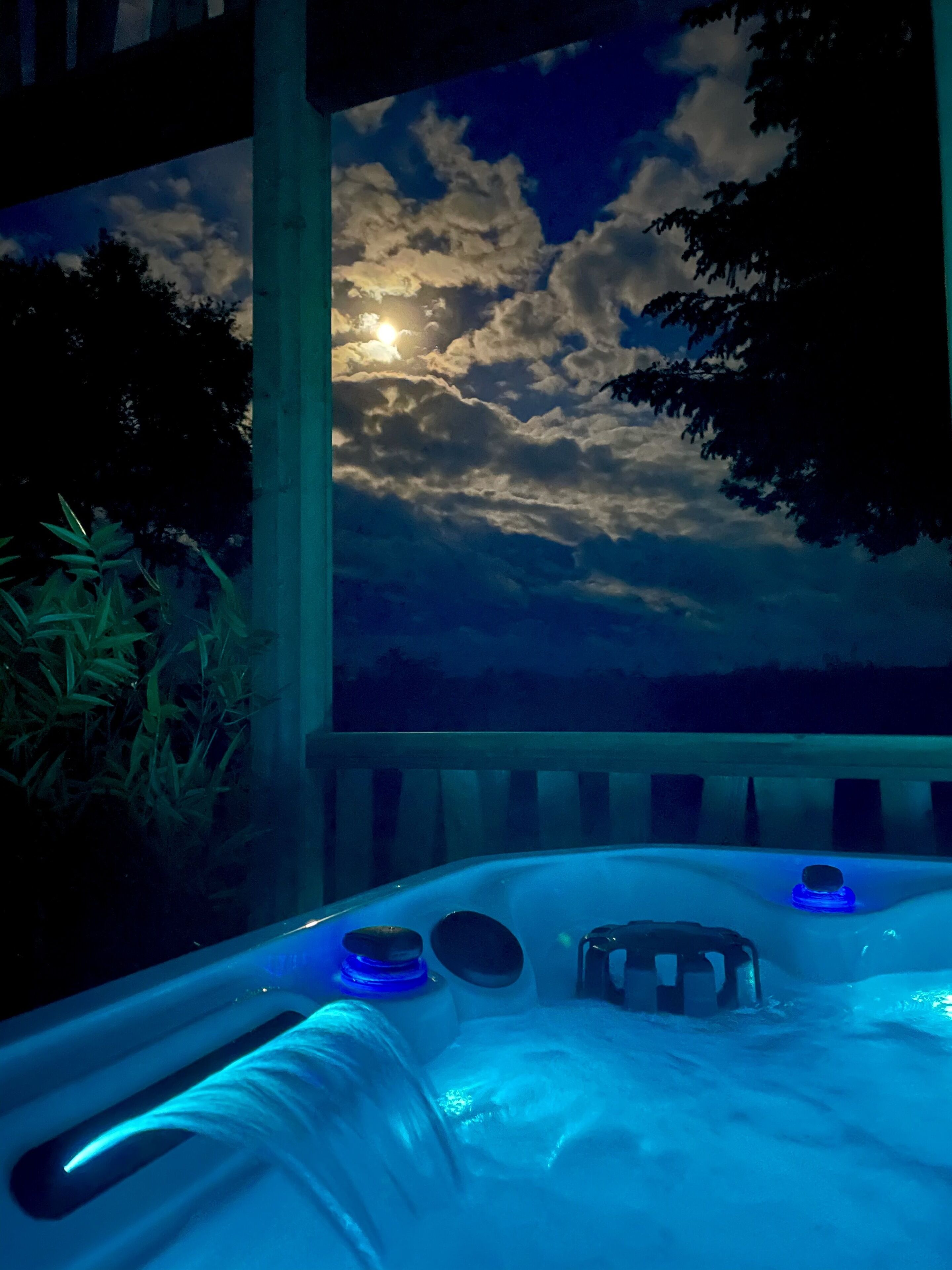 A hot tub with a view of the sky and clouds.