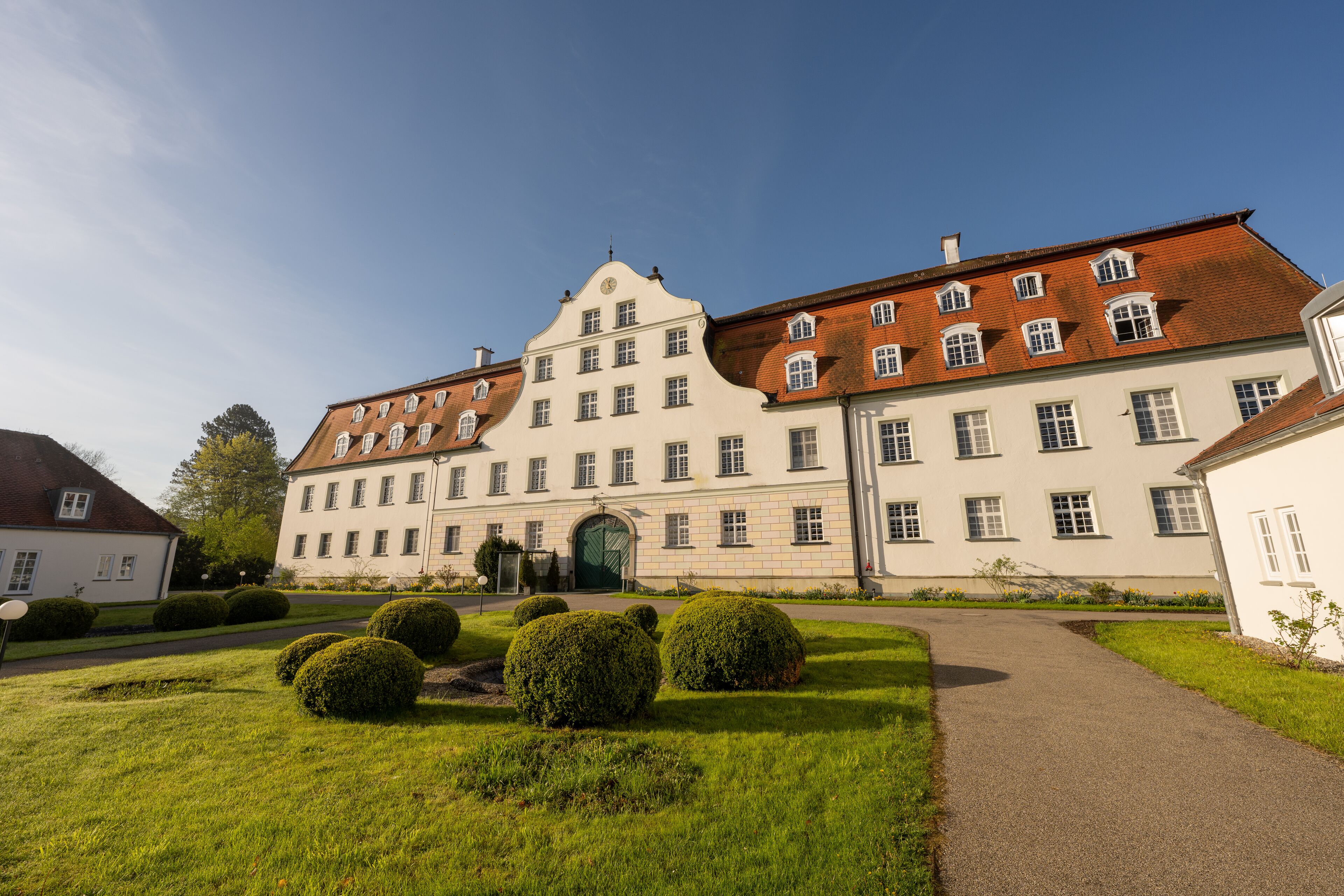 A large, historic building with a symmetrical facade, multiple windows, and a central entrance.