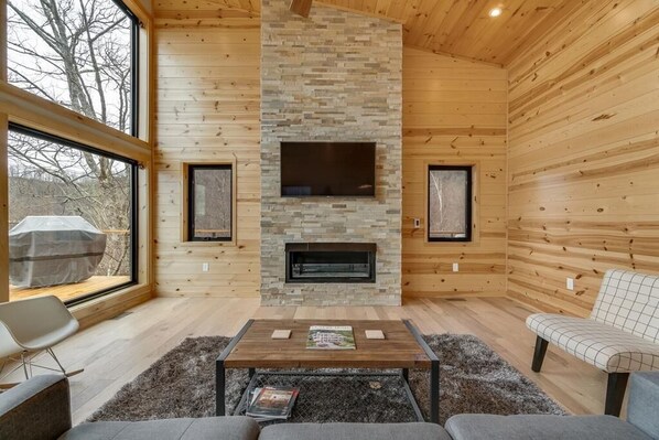 Cozy space with a fireplace, flat-screen TV, and seating area.