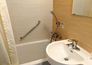 A bathroom with a bathtub, a white sink, a handheld showerhead, and a grab bar. - Wide bed single bed width 140cm WiFi correspond / Osaka Ōsaka (Osaka)