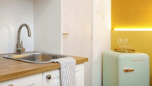 A kitchen with a stainless steel sink, wooden countertop, and a vintage light blue refrigerator with the word "CREATE" on it. - Brand New Guest room in the City Center★Free Wifi (Trieste)