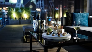 A table set with a bottle, glasses, and small dishes, likely for a meal or drink. - The Tower Hotel Nagoya (Nagoya)