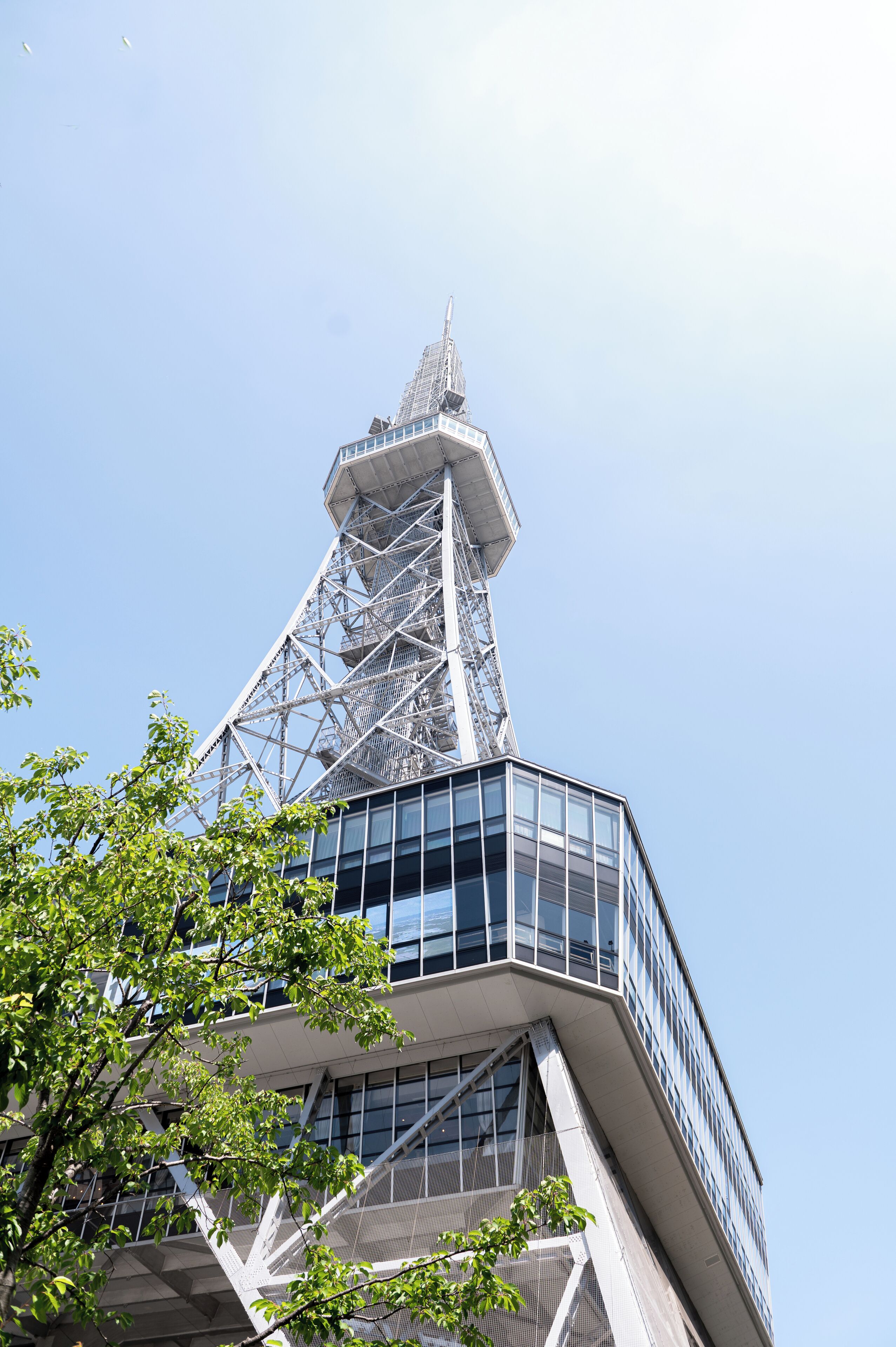 A modern building with a distinctive triangular tower and a glass facade.